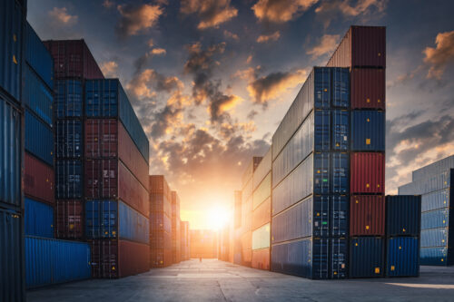 Shipping containers in front of a sunset